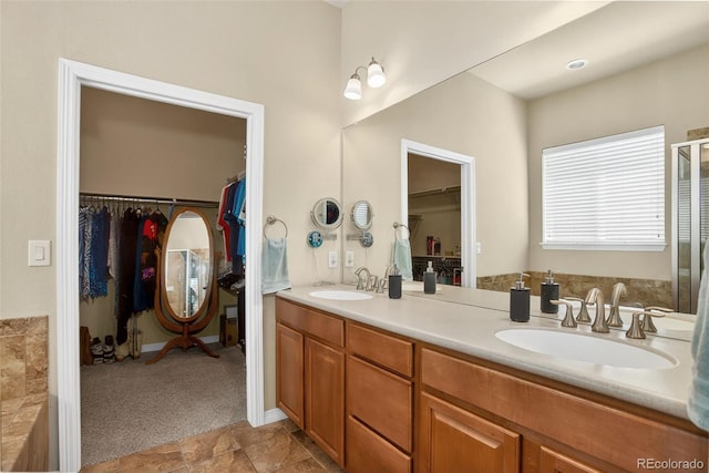 8582 E 148th Ln, Thornton, CO 80602 - bathroom featuring double vanity and a walk in closet