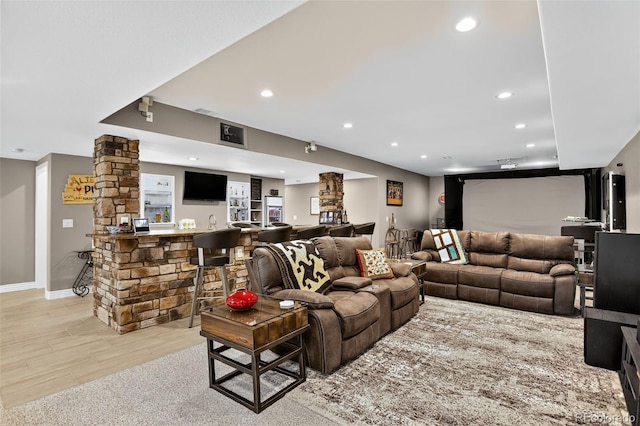 8582 E 148th Ln, Thornton, CO 80602 - living room with recessed lighting, bar area, light wood-type flooring, and decorative columns