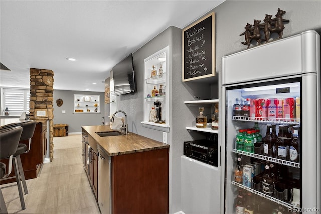 8582 E 148th Ln, Thornton, CO 80602 - bar area with white refrigerator, dishwasher, light wood-style floors, recessed lighting, and decorative columns