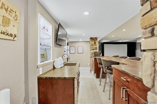 8582 E 148th Ln, Thornton, CO 80602 - kitchen featuring decorative columns, recessed lighting, and brown cabinetry