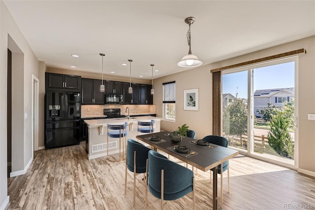 dining room featuring light wood-type flooring and sink