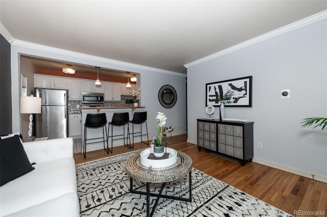 living room with crown molding and dark hardwood / wood-style floors