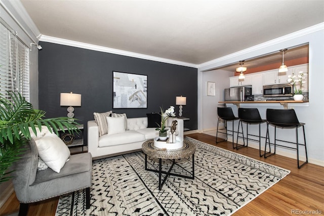 living room featuring light wood-type flooring and ornamental molding