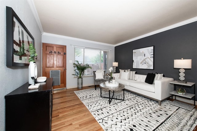 living room with crown molding and hardwood / wood-style flooring