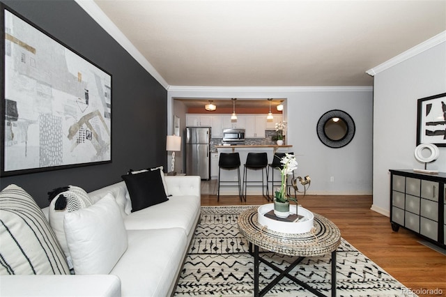 living room with wood-type flooring and crown molding