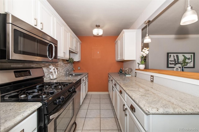 kitchen with white cabinetry, ornamental molding, pendant lighting, and appliances with stainless steel finishes