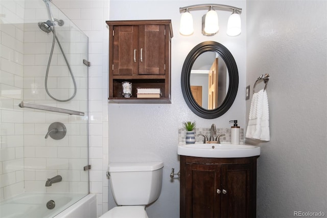 full bathroom with vanity, toilet, and tiled shower / bath