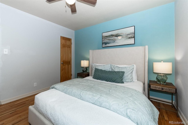 bedroom with hardwood / wood-style floors and ceiling fan