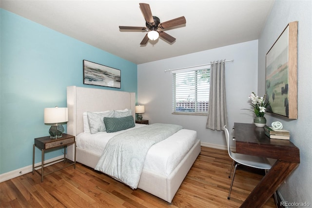 bedroom with ceiling fan and hardwood / wood-style flooring