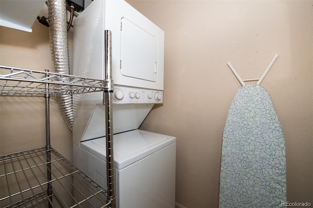 clothes washing area with stacked washer and clothes dryer