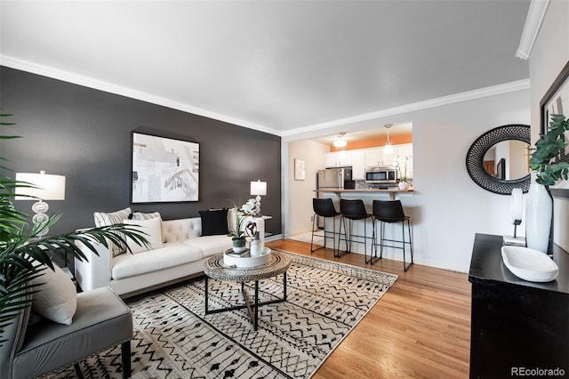 living room with light hardwood / wood-style flooring and ornamental molding