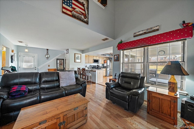 living room with light wood-type flooring and plenty of natural light