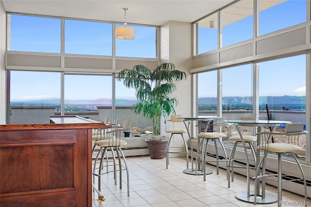 550 E 12th Ave Unit 209, Denver, CO 80203 - sunroom / solarium featuring a mountain view and baseboard heating