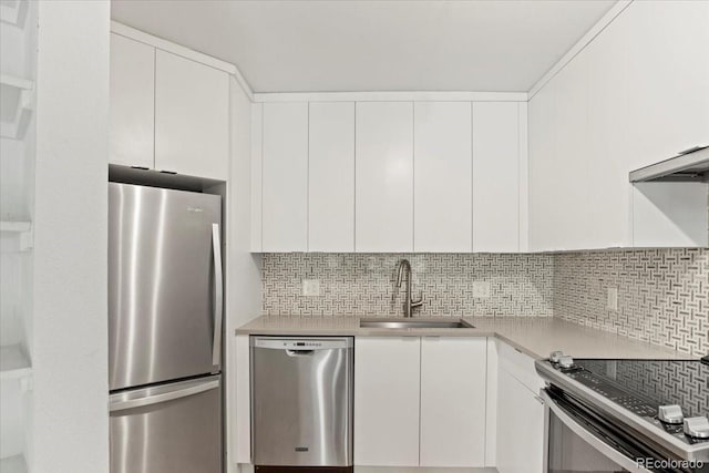550 E 12th Ave Unit 209, Denver, CO 80203 - kitchen with appliances with stainless steel finishes, a sink, light countertops, white cabinets, and tasteful backsplash
