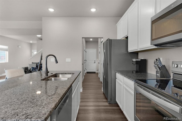 kitchen with sink, light stone counters, dark hardwood / wood-style flooring, white cabinetry, and stainless steel appliances