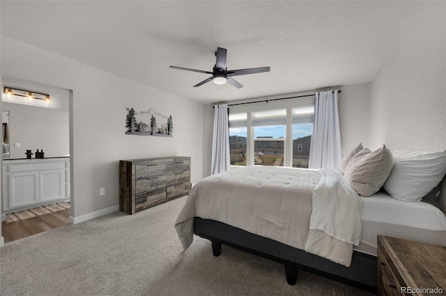 bedroom featuring carpet flooring, a textured ceiling, and ceiling fan