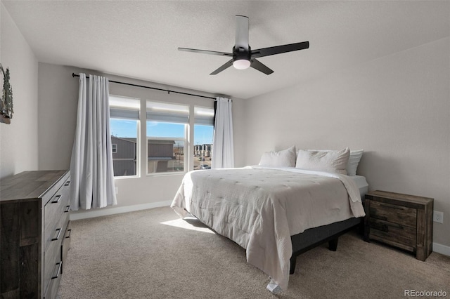 bedroom with light carpet, a textured ceiling, and ceiling fan