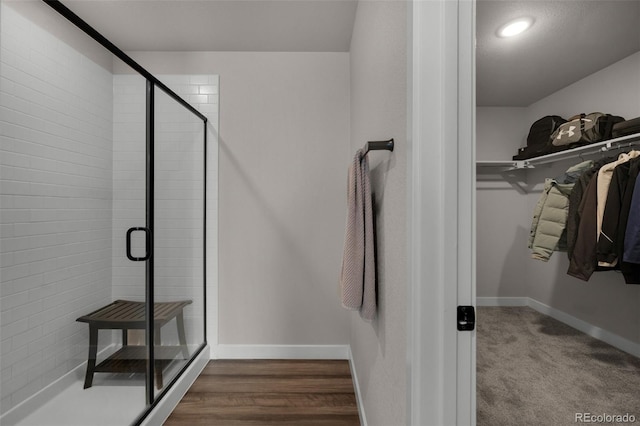 bathroom with wood-type flooring and walk in shower