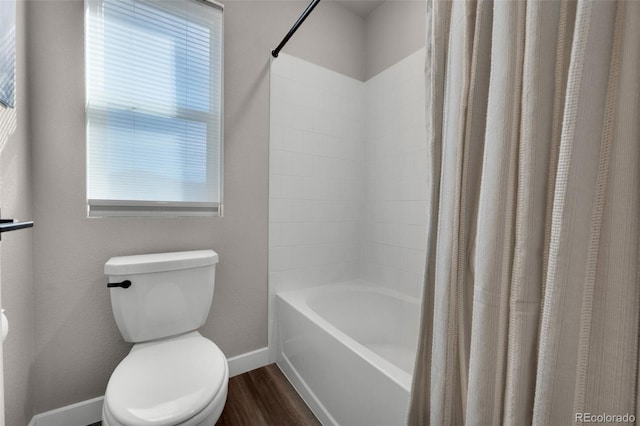 bathroom featuring hardwood / wood-style floors, toilet, and shower / tub combo