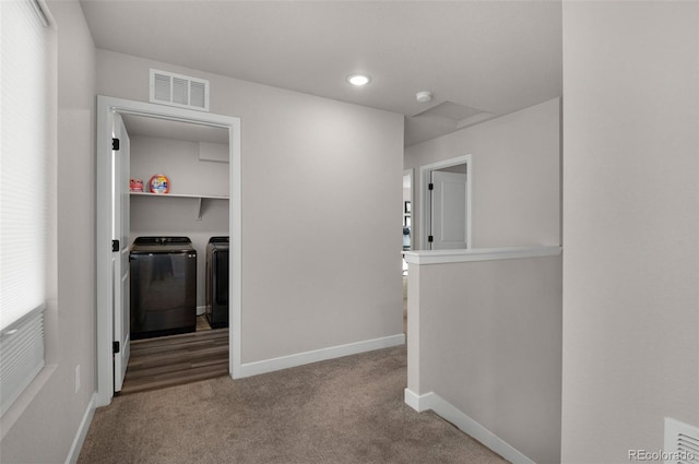 corridor with carpet, a healthy amount of sunlight, and independent washer and dryer