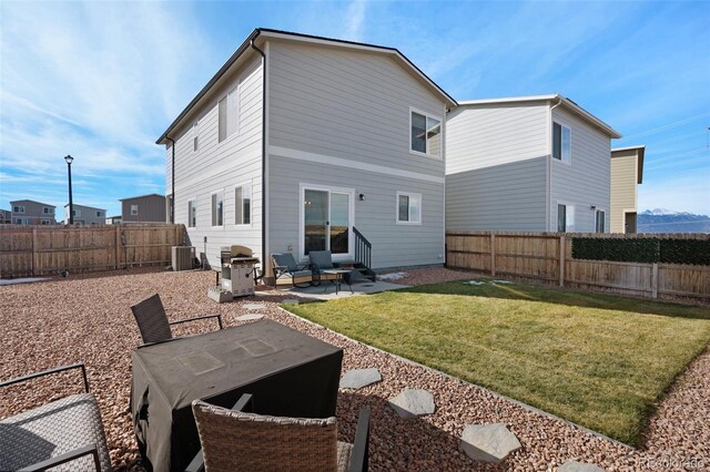 back of property featuring a lawn, a patio area, and central AC unit