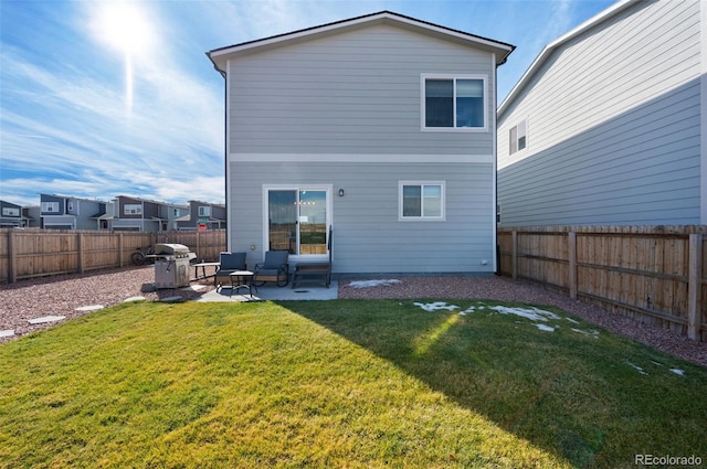 back of property featuring a yard, a patio, and an outdoor hangout area