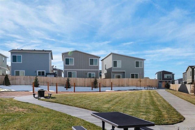 view of home's community featuring a lawn