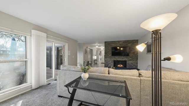 carpeted living room featuring a fireplace