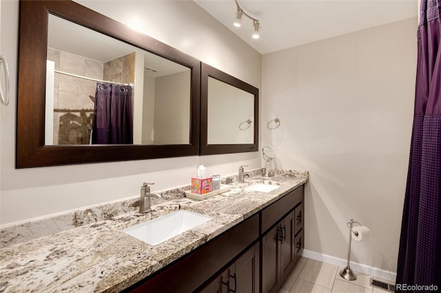 bathroom featuring walk in shower, vanity, and tile patterned flooring