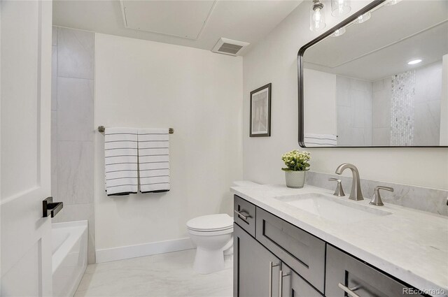 1304 Snowberry Unit 103, Louisville, CO 80027 - full bathroom featuring visible vents, a bath, baseboards, toilet, and vanity
