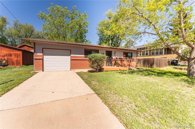 1528 N Chestnut St, Colorado Springs, CO 80907 - view of front facade with brick siding, an attached garage, and concrete driveway