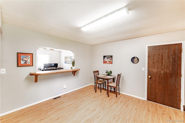 1528 N Chestnut St, Colorado Springs, CO 80907 - dining area with wood finished floors, baseboards, and arched walkways