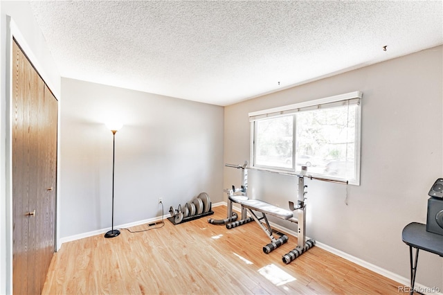 1528 N Chestnut St, Colorado Springs, CO 80907 - workout area with wood finished floors, a textured ceiling, and baseboards
