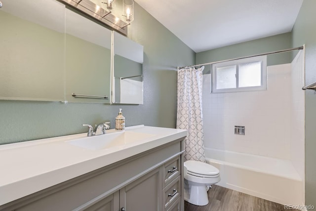 full bathroom with hardwood / wood-style flooring, toilet, vanity, and shower / bath combo with shower curtain