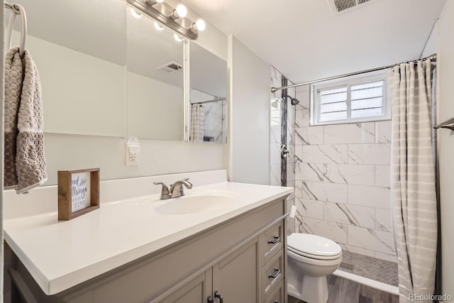 bathroom with walk in shower, vanity, toilet, and hardwood / wood-style floors