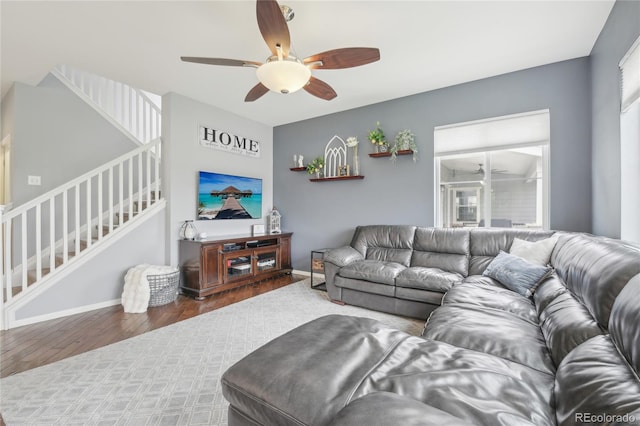 16226 W 94th Dr, Arvada, CO 80007 - living area featuring ceiling fan, stairs, wood finished floors, and baseboards