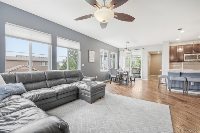 16226 W 94th Dr, Arvada, CO 80007 - living area featuring light wood-style flooring, a ceiling fan, baseboards, and recessed lighting