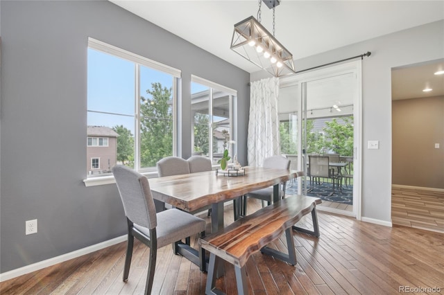16226 W 94th Dr, Arvada, CO 80007 - dining area featuring wood-type flooring, baseboards, and plenty of natural light