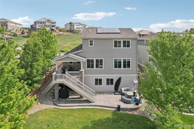 16226 W 94th Dr, Arvada, CO 80007 - rear view of house featuring a patio, stairs, roof mounted solar panels, a yard, and a deck