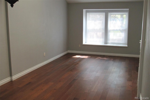 14503 E Wagon Trail Dr, Aurora, CO 80015 - spare room with baseboards and dark wood-type flooring