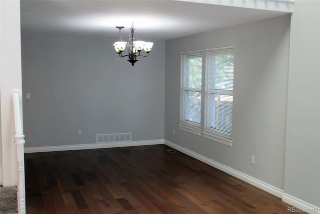 14503 E Wagon Trail Dr, Aurora, CO 80015 - empty room featuring a chandelier, dark wood-type flooring, and baseboards