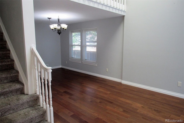 14503 E Wagon Trail Dr, Aurora, CO 80015 - stairs with wood finished floors, a chandelier, and baseboards