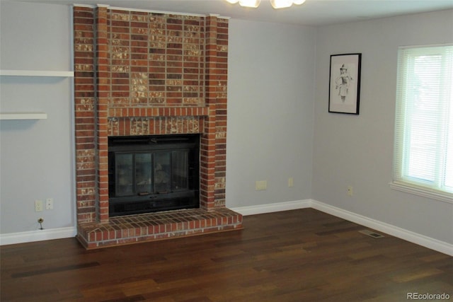 14503 E Wagon Trail Dr, Aurora, CO 80015 - detailed view of wood finished floors, a brick fireplace, and baseboards