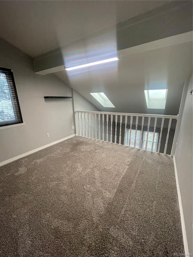 14503 E Wagon Trail Dr, Aurora, CO 80015 - unfurnished room featuring a skylight, carpet floors, lofted ceiling, and baseboards