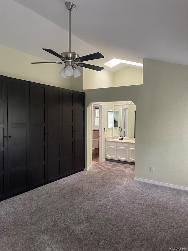14503 E Wagon Trail Dr, Aurora, CO 80015 - unfurnished bedroom with a skylight, vaulted ceiling, carpet floors, baseboards, and ensuite bathroom