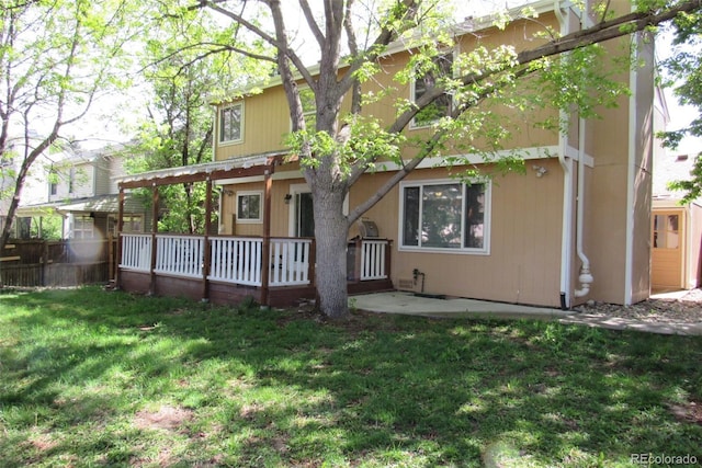 14503 E Wagon Trail Dr, Aurora, CO 80015 - back of house featuring a lawn and a wooden deck