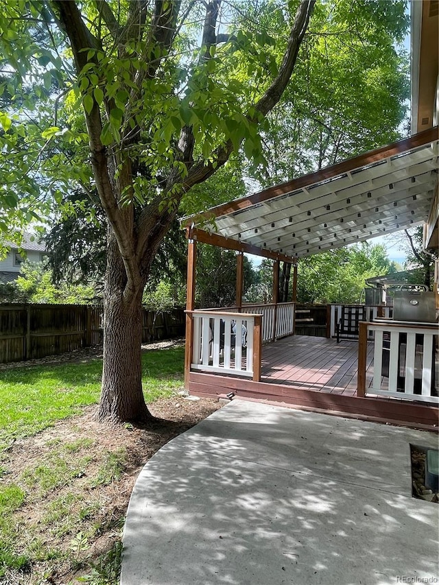 14503 E Wagon Trail Dr, Aurora, CO 80015 - wooden deck with a fenced backyard and a patio