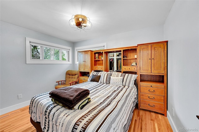 2201 Lima St, Aurora, CO 80010 - bedroom with light wood-style flooring, baseboards, and visible vents