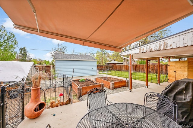 2201 Lima St, Aurora, CO 80010 - view of patio / terrace featuring a fenced backyard, a grill, outdoor dining space, and a garden