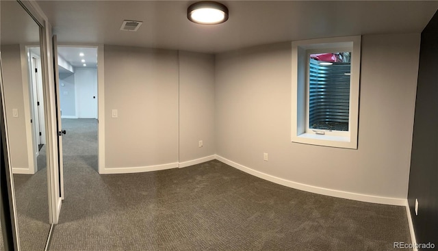 2201 Lima St, Aurora, CO 80010 - unfurnished room with baseboards, dark carpet, and visible vents